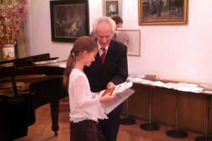 The youngest participant - Marta Czech (Poland) receiving Diploma of Participation and gifts.